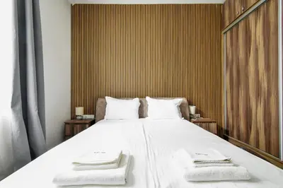 a bedroom with a large white bed with towels on it at Blue Breeze Apartment by Flat Mаnager in Sofia