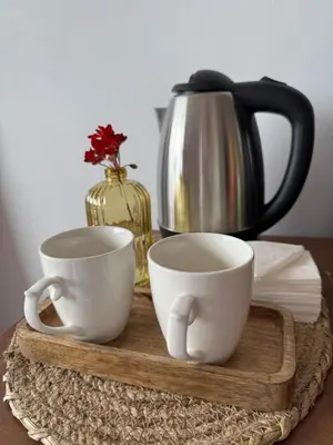 two cups on a wooden tray with a coffee pot at Stenata LightWill in Banya
