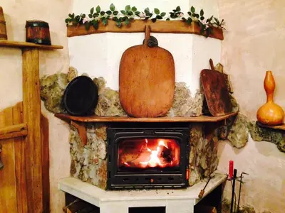 a fireplace with a pumpkin on top of it at Тристаен апартамент 1А17 Гранд Манастира Пампорово in Pamporovo