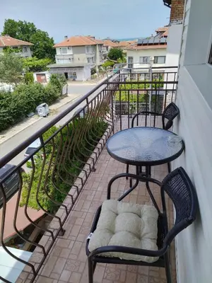 a table and two chairs on a balcony at Къща за гости Св Никола in Tschepinzi
