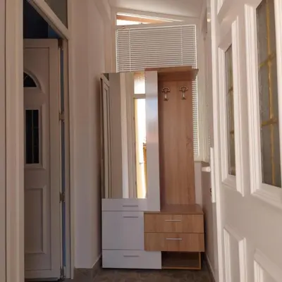 a bathroom with a mirror and a wooden dresser at Асклепион in Kyustendil