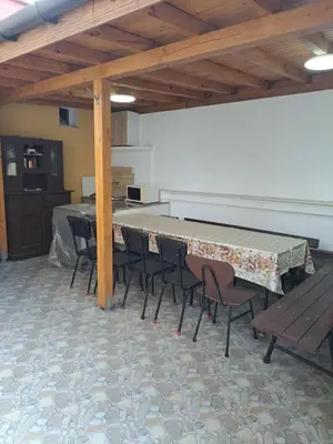 a conference room with a table and chairs and a counter at Асклепион in Kyustendil