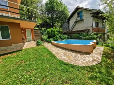 a backyard with a swimming pool and a house at Villa Aqua in Pravets