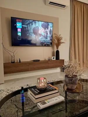 a living room with a flat screen tv on the wall at Light View Apartment - New Center in Sofia