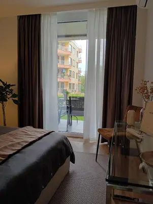 a bedroom with a bed and a view of a building at Light View Apartment - New Center in Sofia