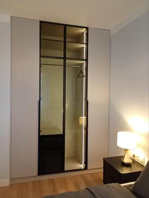 a glass wardrobe in a bedroom with a lamp at Light View Apartment - New Center in Sofia