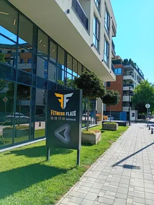 a sign on the grass in front of a building at Light View Apartment - New Center in Sofia