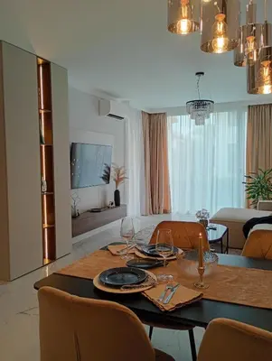 a dining room with a table with glasses and chairs at Light View Apartment - New Center in Sofia
