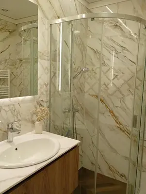 a bathroom with a sink and a glass shower at Light View Apartment - New Center in Sofia