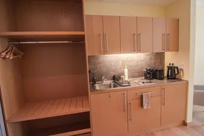 a kitchen with wooden cabinets and a sink at Deno Studio in Borovets
