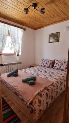 a bedroom with a bed with two towels on it at Вила Зора in Chepelare