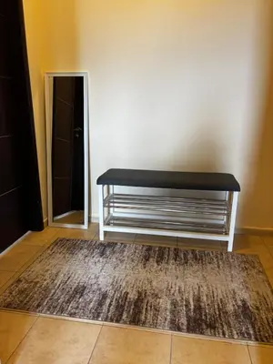 a bench sitting in a room with a rug at Alpine Lodge Chalet in Bansko in Bansko