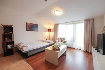 a bedroom with a bed and a table and a tv at Bansko 1BR for 4 w Balcony View Spa Near Ski Lift in Bansko