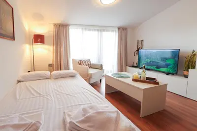 a bedroom with a bed and a living room at Bansko 1BR for 4 w Balcony View Spa Near Ski Lift in Bansko