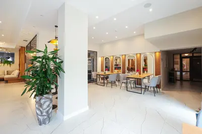 a dining room with tables and chairs and a plant at Bansko 1BR for 4 w Balcony View Spa Near Ski Lift in Bansko