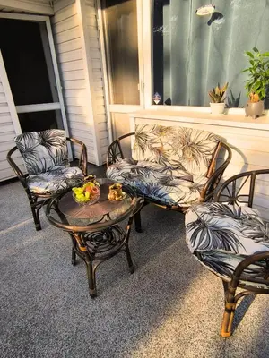 a porch with a couch and two chairs and a table at City Garden - Amazing Garden for party and friends in Kostinbrod