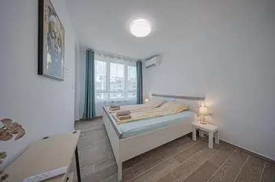 a small bedroom with a bed and a window at NOAR - Free parking - Metro access in Sofia