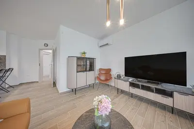 a living room with a large flat screen tv at NOAR - Free parking - Metro access in Sofia