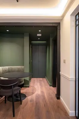 a hallway with a table and chairs in a building at Private Premium Apartment in Plovdiv in Plovdiv