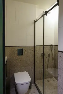 a bathroom with a toilet and a glass shower at Private Premium Apartment in Plovdiv in Plovdiv