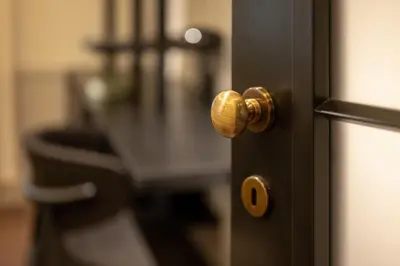 a door with a gold door knob on a table at Private Premium Apartment in Plovdiv in Plovdiv