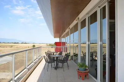 a balcony with a table and chairs on it at Хотел Летище Лесново in Ormanliya