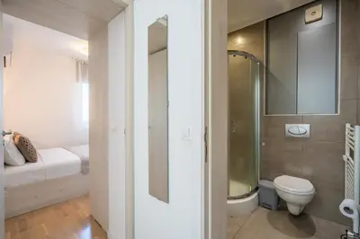 a small bathroom with a toilet and a shower at SOFIA41 - Prime Location in Sofia