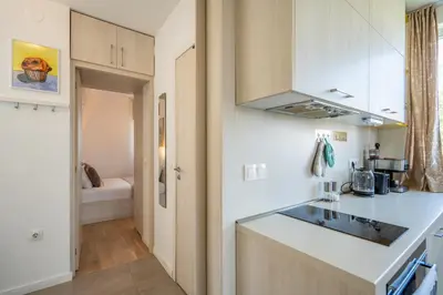a kitchen with white cabinets and a counter top at SOFIA41 - Prime Location in Sofia