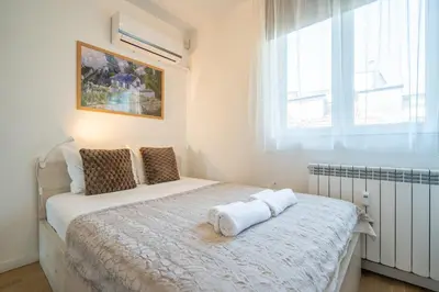 a bedroom with a bed with towels on it at SOFIA41 - Prime Location in Sofia