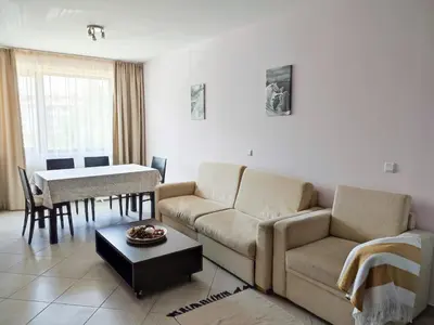 a living room with a couch and a table at Green Life Private Apartment D25 in Bansko