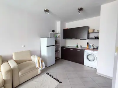 a kitchen with a white refrigerator and a washing machine at Green Life Private Apartment D25 in Bansko