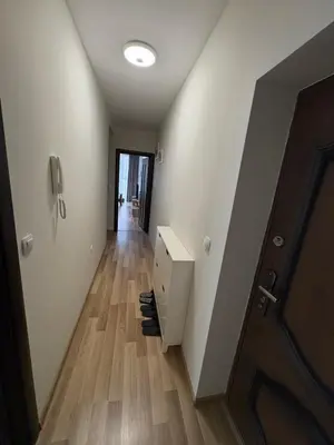 a hallway with a desk and a hallway with a door at Nikea apart 2 in Velingrad