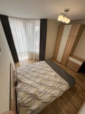 a bedroom with a bed in a room with a window at Nikea apart 2 in Velingrad