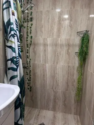 a bathroom with a shower with a toilet and a sink at Damyanov residence in Pazardzhik