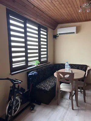 a living room with a couch and a table and a bike at Damyanov residence in Pazardzhik