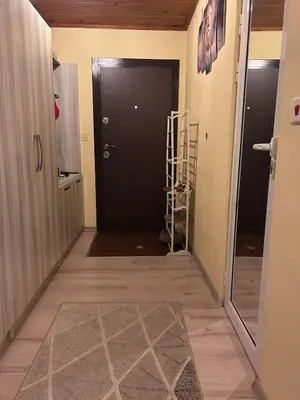 a hallway with a black door and a room at Damyanov residence in Pazardzhik