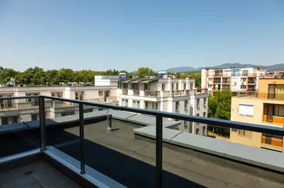a view of a city from a balcony at Просторен апартамент за семейна почивка in Hisarya