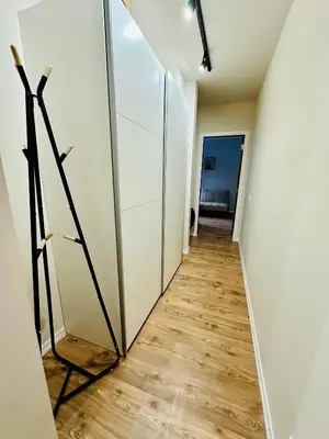 a hallway with white walls and a wooden floor at Grand Resort Pamporovo b19 in Pamporovo