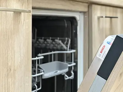 a door of a dishwasher with a rack in it at Charming 2BD with Mountain View by Flat Mаnager in Sofia