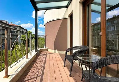 a balcony with two chairs and a glass table at Charming 2BD with Mountain View by Flat Mаnager in Sofia
