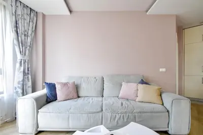 a living room with a couch with pillows on it at Charming 2BD with Mountain View by Flat Mаnager in Sofia