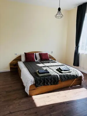 a bedroom with a bed with two towels on it at Spacious&Cousy 3 bedroom apartment in Plovdiv