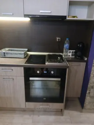 a kitchen with a stove top oven in a kitchen at Zoraja in Sofia