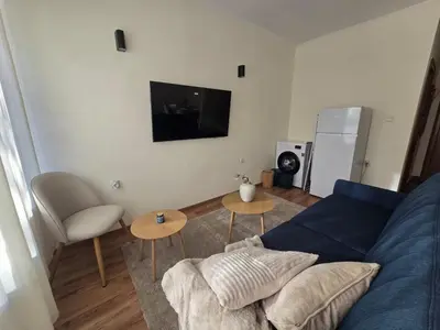 a living room with a blue couch and a tv at Modern Studio near Ski Lift - Cedar Lodge 4,Bansko by Flat Mаnаger in Bansko