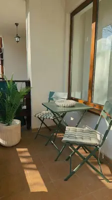 a green table and two chairs in a room at Modern Studio near Ski Lift - Cedar Lodge 4,Bansko by Flat Mаnаger in Bansko