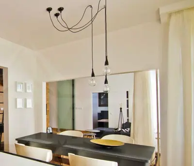 a dining room with a black table and chairs at Casa Desideria 2BAD 2BATH, PARKING , Vitosha Blvd in Sofia