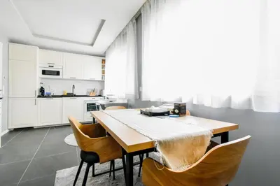 a kitchen with a wooden table and chairs at Bright Central Sofia Flat with Coffee-Lovers Touch by Flat Mаnager in Sofia