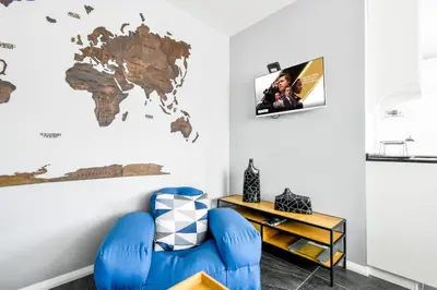 a room with a blue chair and a map on the wall at Bright Central Sofia Flat with Coffee-Lovers Touch by Flat Mаnager in Sofia
