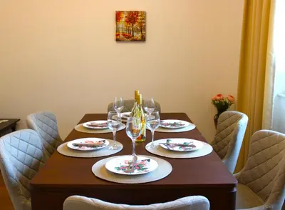 a wooden table with glasses of wine on it at Bright & Cozy Apartment for 4 Guests in Plovdiv Centre in Plovdiv