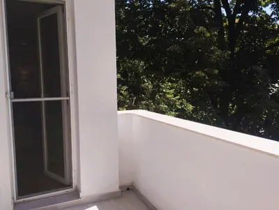 an open window on the side of a white building at Bright & Cozy Apartment for 4 Guests in Plovdiv Centre in Plovdiv